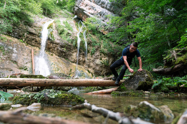istock Young Caucasian man walking over rocks and branches 1279998685
