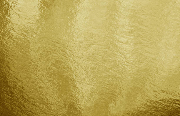 istock Gold foil background with highlights and uneven texture 1280001408