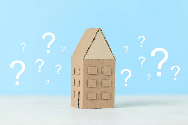 istock A question on a small house, a magnifying glass examines the building. Assistance in choosing and buying real estate 1280002027