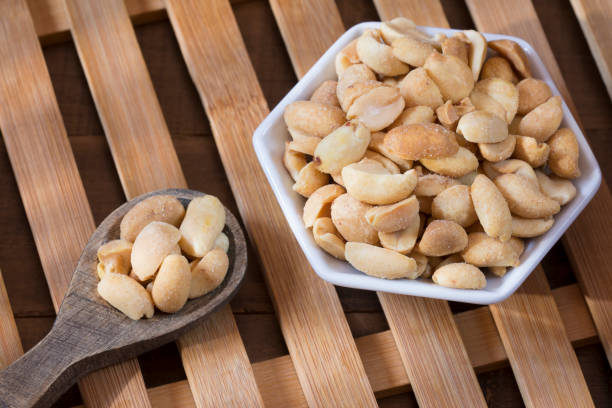 istock Peeled and salted peanuts - Arachis hypogaea 1280002383