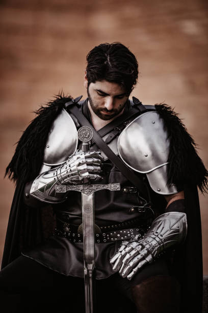 istock Medieval fantasy knight sitting alone and looking down 1280003112