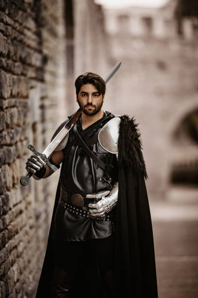 istock Black medieval fantasy knight with his sword lying on his shoulder 1280003842