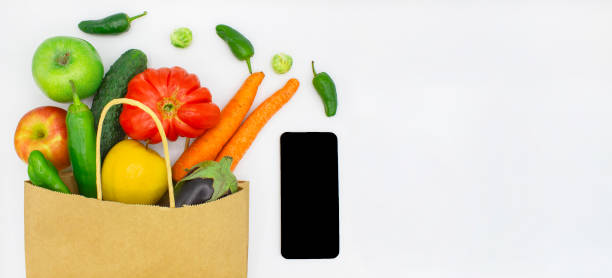 istock Shopping bag with vegetables and mobile phone 1280003871