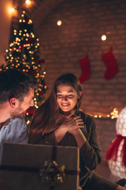istock Couple opening Christmas presents 1280005184