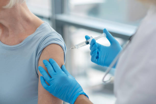istock Close up picture of nurses hands holding a syringe before vaccination 1280005190