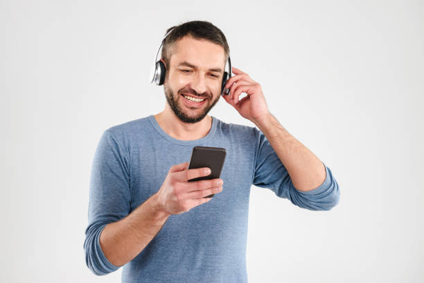 istock Happy man isolated music using mobile phone. 1280005353