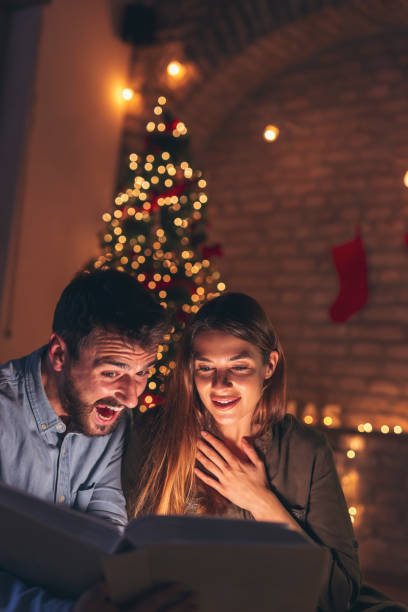 istock Couple looking old photos while spending Christmas Eve at home 1280005362