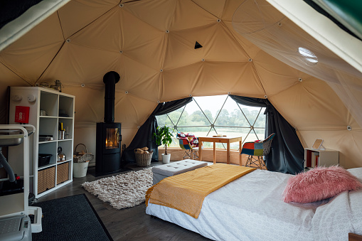 Interior of the living space of a space-age style dome tent at a glamping site in Northumberland.