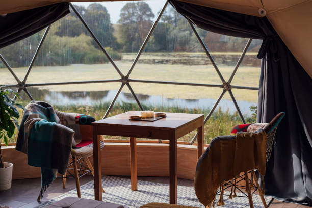 Tent With a View Interior of a dome tent at a glamping site in Northumberland. There is a window looking out at a lake. dome tent photos stock pictures, royalty-free photos & images