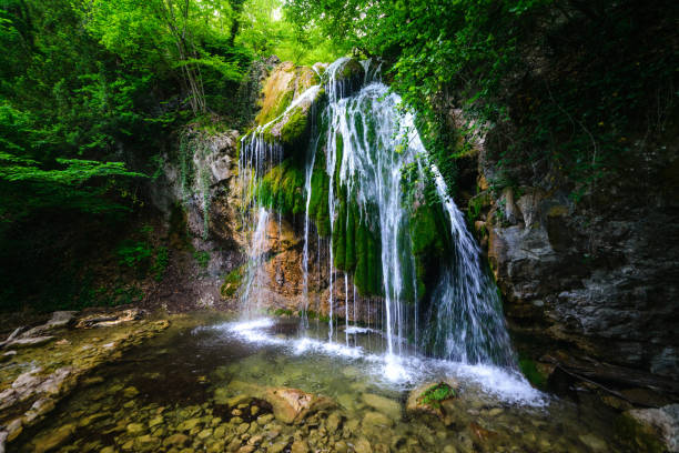 istock Picturesque waterfall in forest 1280006858