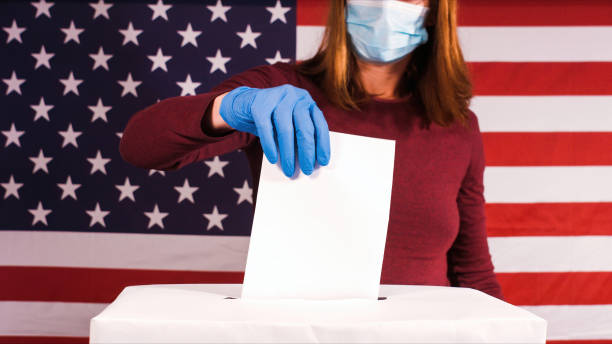 istock Woman with face mask and gloves voting 1280007025
