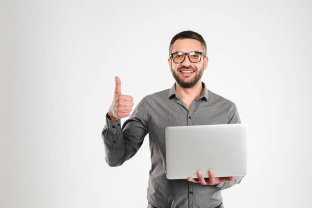 istock Happy businessman using laptop computer showing thumbs up. 1280007447