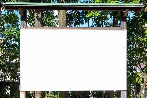 Large blank white board outside in sunny day