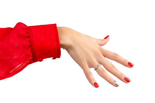 Hand with manicure isolated on white background with copy space. Red and silver glitter nail design.