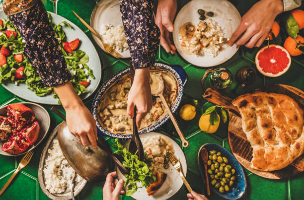 istock Flat-lay of people having Turkish dinner with lamb, rice, salad 1280009996