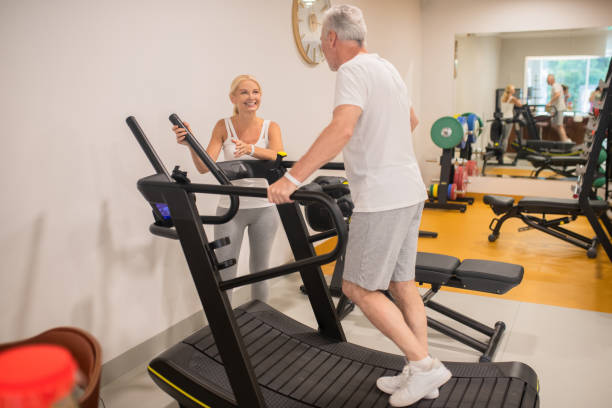 istock A man and a woman exercising on treadmills 1280011570