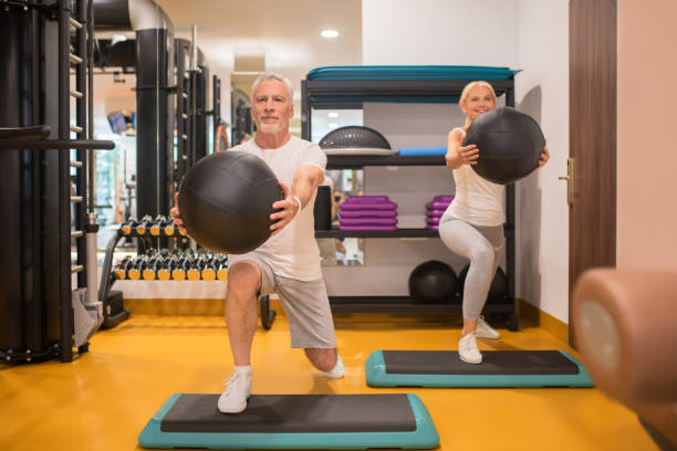 istock A man and a woman doing lunging with balls 1280012339