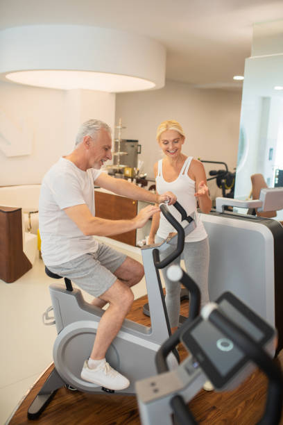 istock Man on a treadmill talking to his female instructor 1280012440