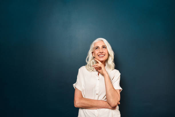 istock Old cheerful woman looking aside isolated 1280012678