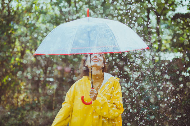 istock Joyful woman walking in rainy weather 1280013048