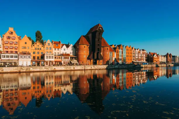 Gdansk Waterfront with crane gate and Motlawa river at sunrise in Poland