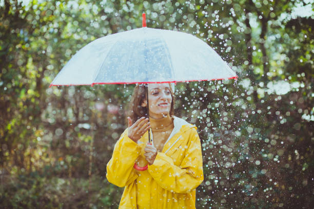 istock Joyful woman walking in rainy weather 1280013885