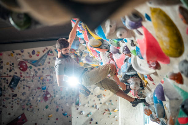 istock Male Climber Reaching into Chalk Bag on Bouldering Wall 1280014225