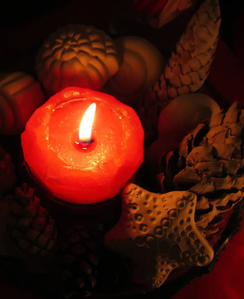 istock Red burning candle with decor of handmade sea shells 1280014290