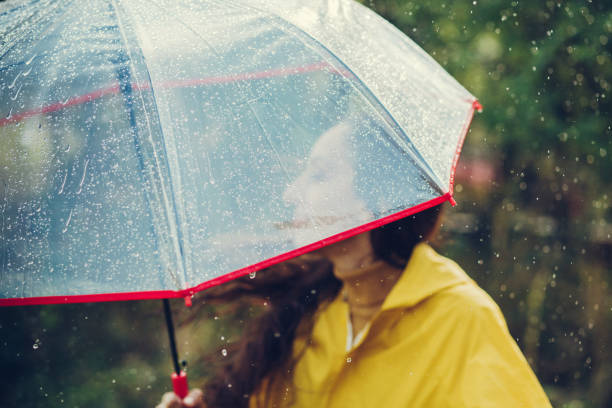 istock Happy girl standing outside during rain 1280015500