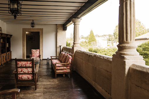 A vintage terrace area with sofas in an old house