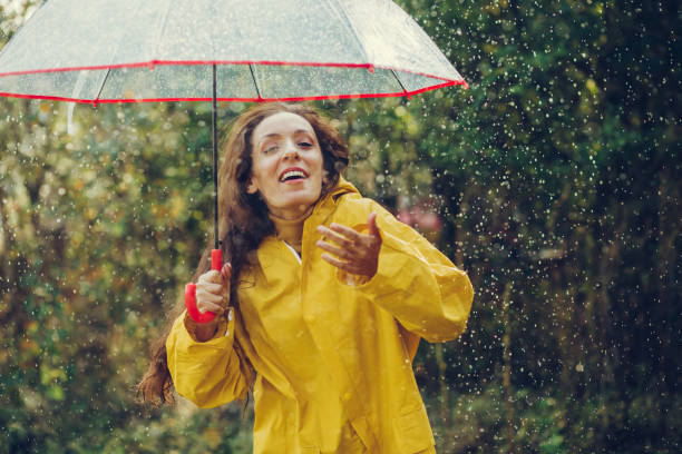 istock Happy girl standing outside during rain 1280015809