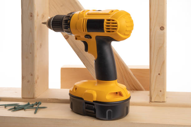 istock a yellow battery operated drill and construction screws in a residential construction framing setting isolated on white 1280015871