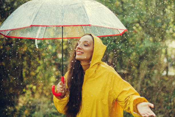 istock Happy girl standing outside during rain 1280015922