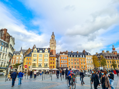 Brussels, Belgium - May 18, 2023: Mount of the Arts (Mont des Arts), view of colorful garden, Equestrian Statue of Albert I and spire of Town Hall