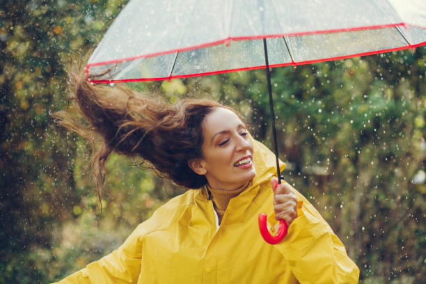 istock Happy girl standing outside during rain 1280016053