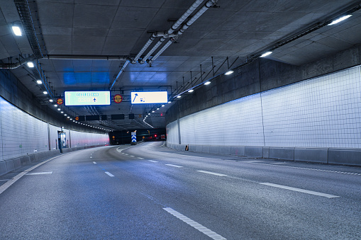 A dark tunnel where cars drive