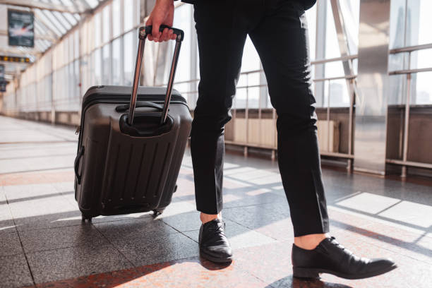 Man carrying his suitcase through the airport