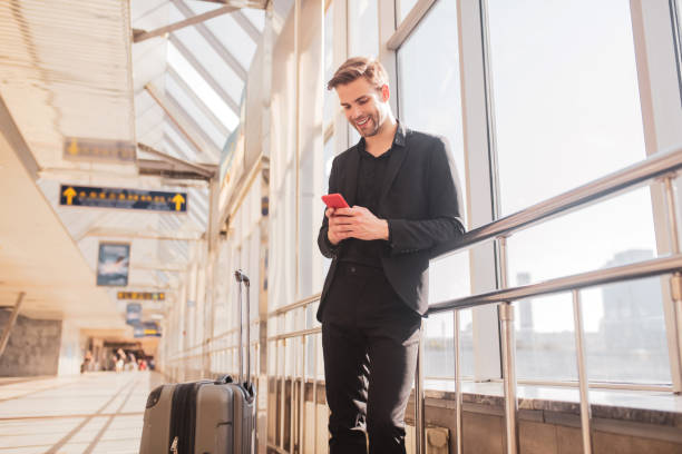 istock Man texting with his friends while waiting for a flight 1280016900