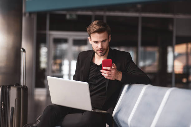 istock Man communicating with colleagues in the airport 1280016944