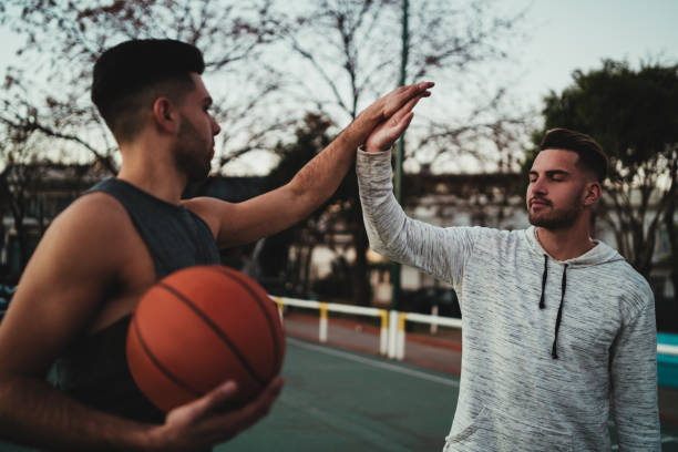 istock Two young friends playing basketball. 1280017115