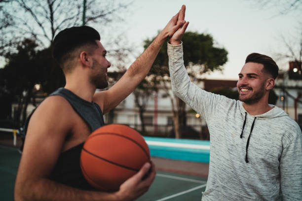 istock Two young friends playing basketball. 1280017116