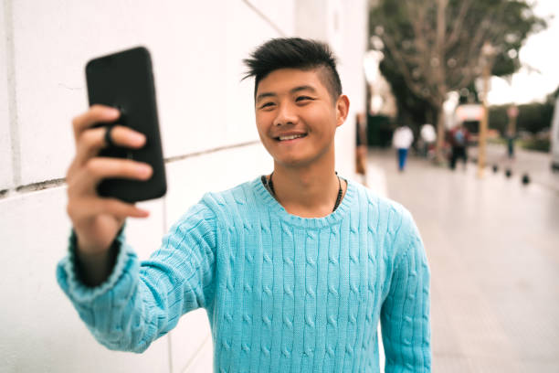 istock Asian man taking a selfie with his mobile phone. 1280017124
