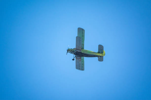 istock Retro biplane plane in the blue sky 1280018451