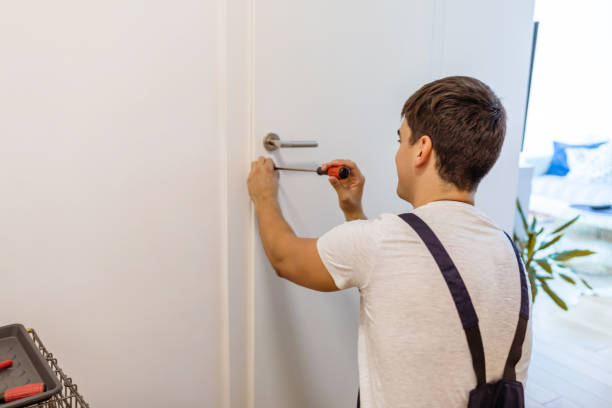 istock Carpenter repairing door lock. Installing a door handle. 1280019549