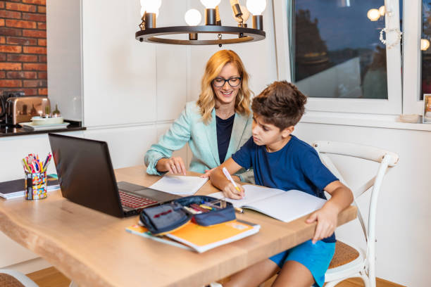 istock Son with their mother doing homework at home 1280019734