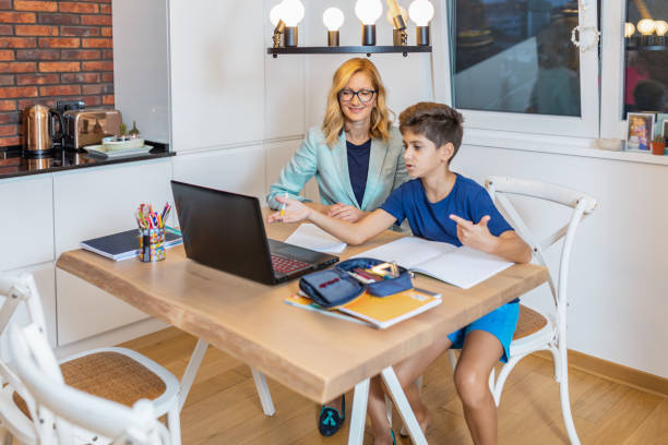 istock Son with their mother doing homework at home 1280019960
