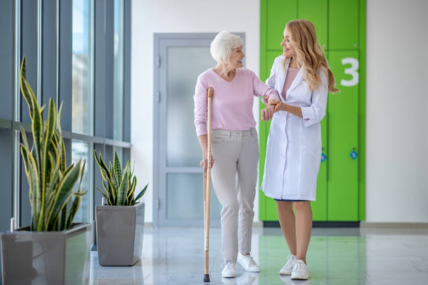istock Doctor in a lab coat and a patient walking together and talking 1280022615