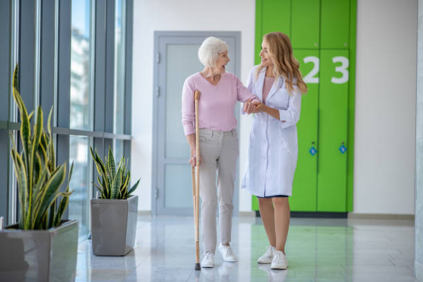 istock Doctor in a lab coat and a patient walking together 1280022620