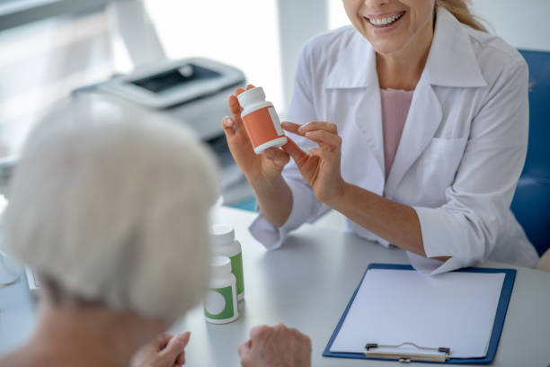 istock Doctor consulting an elderly patient regarding medication 1280022650