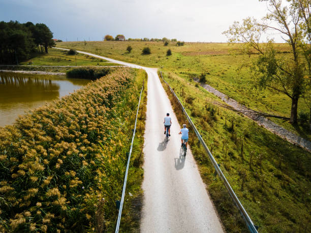istock Men riding bicycle in the nature outdoors aerial top view 1280022970